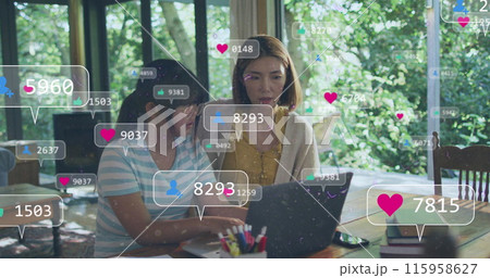 Asian teacher and student, both female, are looking at laptop Asian teacher and student, both female, are looking at laptop 115958627