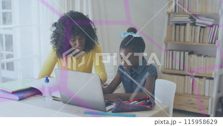 African American mother and daughter are looking at laptop in a home office African American mother and daughter are looking at laptop in a home office 115958629