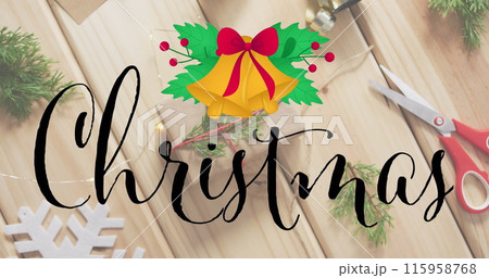 Wooden table holds Christmas decorations, scissors, and string for wrapping gifts 115958768