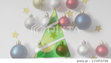 Ornaments and gold stars around paper Christmas tree 115958786