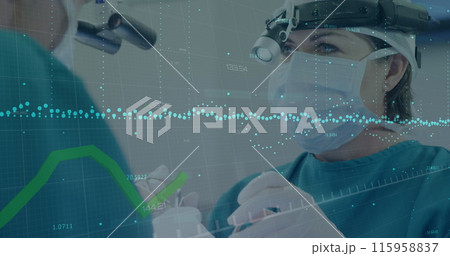 Caucasian female doctor wearing surgical gear is performing surgery 115958837