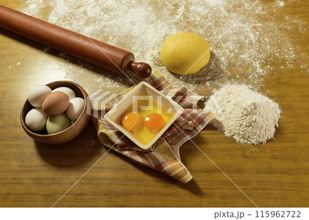 Egg dough for noodles, with ingredients on the table, traditional italian cuisine. Egg dough for noodles, with ingredients on the table, traditional italian cuisine. 115962722