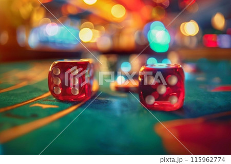 Two red dices on a casino table with bokeh background 115962774