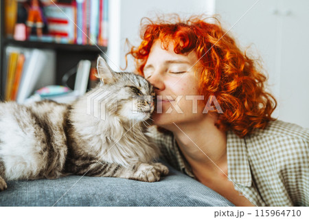 portrait red-haired attractive young woman with fluffy big cat 115964710