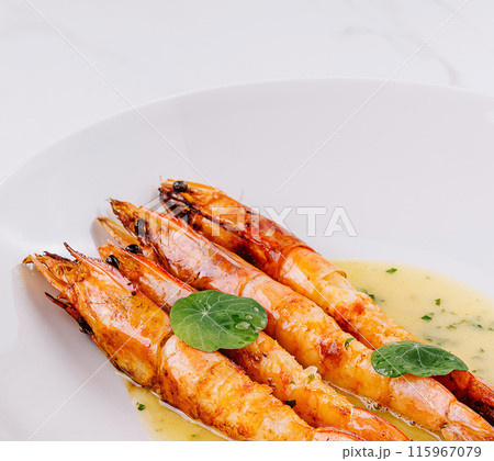 Grilled shrimp with garlic sauce on white plate Grilled shrimp with garlic sauce on white plate 115967079