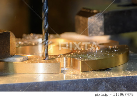 The hole drilling  process on NC milling machine with brass material parts. 115967479