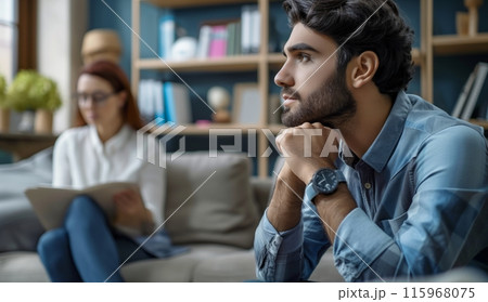 Man Sitting On Couch In Room 115968075