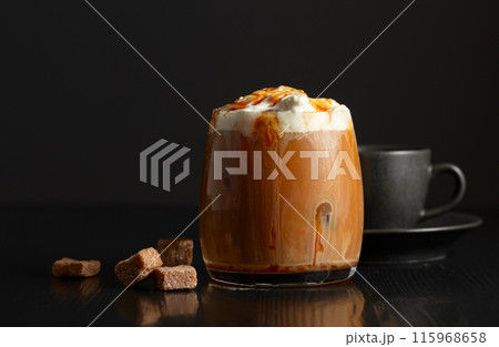 Iced coffee with whipped cream and caramel sauce and cup of black coffee. 115968658