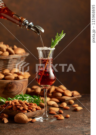 Italian liqueur Amaretto with almonds nuts on a wintage table. 115968695