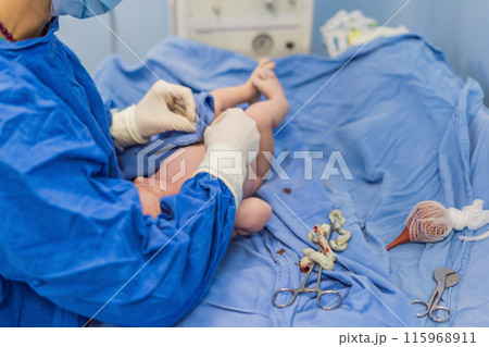 A nurse caring for a newborn baby in a hospital setting. The nurse provides gentle and attentive care, ensuring the baby's comfort and well-being A nurse caring for a newborn baby in a hospital setting. The nurse provides gentle and attentive care, ensuring the baby's comfort and well-being 115968911