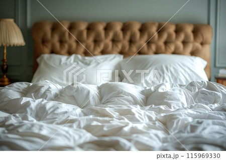 Cozy White Bedding on Bed Against Softly Blurred Bedroom Background 115969330