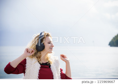 Happy woman wearing headphones outdoor Happy woman wearing headphones outdoor 115969667