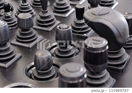 Various control sticks on a black dashboard 115969787