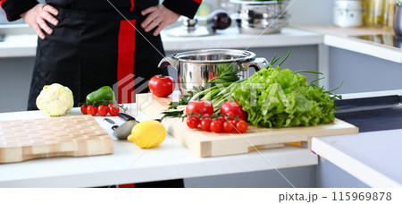 The cook in the kitchen is preparing The cook in the kitchen is preparing 115969878