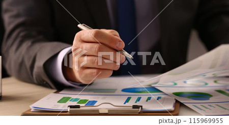 Male hand in suit hold siver pen in office 115969955