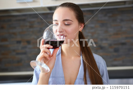 Beautiful woman hold in arms glass of red wine 115970151