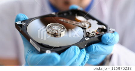 A male repairman wearing blue gloves 115970238