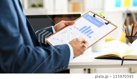 Male arm in suit show stats graphic clipped to pad Male arm in suit show stats graphic clipped to pad 115970395