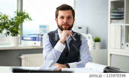Handsome smiling bearded clerk man at office workplace Handsome smiling bearded clerk man at office workplace 115970396