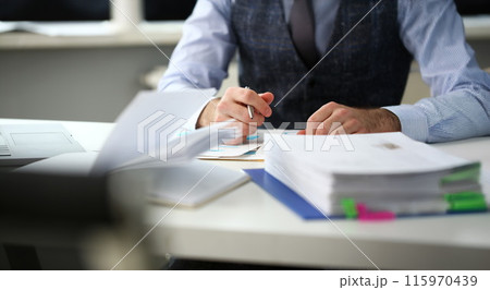 Clerk man at office workplace with silver pen in arms Clerk man at office workplace with silver pen in arms 115970439