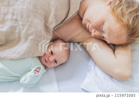 A baby lies with the mother after childbirth, resting peacefully. The serene moment captures the bond between mother and child as they begin their journey together. The hospital environment ensures a 115971085