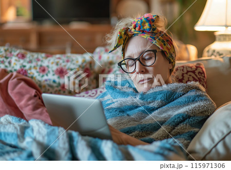 Exhausted woman working on laptop in bed 115971306