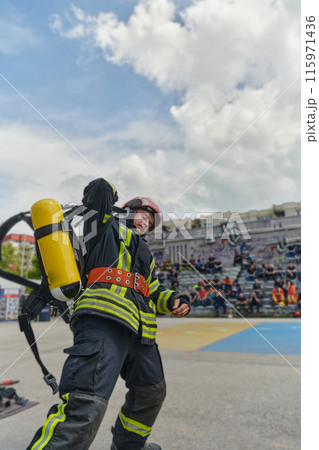 A firefighter dons the essential components of their professional gear, embodying resilience, commitment, and readiness as they gear up for a hazardous firefighting mission, a testament to their A firefighter dons the essential components of their professional gear, embodying resilience, commitment, and readiness as they gear up for a hazardous firefighting mission, a testament to their 115971436
