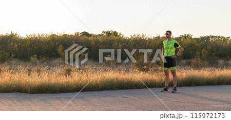 A triathlete resting after a hard morning's run. Training preparation for the upcoming marathon A triathlete resting after a hard morning's run. Training preparation for the upcoming marathon 115972173