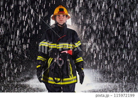 A determined female firefighter in a professional uniform striding through the dangerous, rainy night on a daring rescue mission, showcasing her unwavering bravery and commitment to saving lives. A determined female firefighter in a professional uniform striding through the dangerous, rainy night on a daring rescue mission, showcasing her unwavering bravery and commitment to saving lives. 115972199
