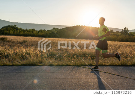 Triathlete in professional gear running early in the morning, preparing for a marathon, dedication to sport and readiness to take on the challenges of a marathon. Triathlete in professional gear running early in the morning, preparing for a marathon, dedication to sport and readiness to take on the challenges of a marathon. 115973216