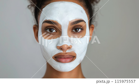 Woman with white clay mask on face, showcasing natural skincare and beauty treatment 115975557