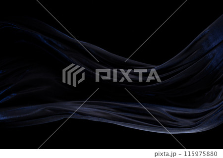Blue silver shinny fabric flying in curve shape, Piece of textile blue silvery fabric throw fall in air. Black background isolated, dark shading environment 115975880