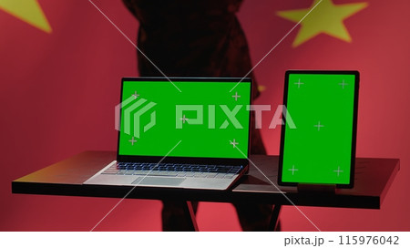 China army soldier using isolated screen laptop and tablet to identify threats from enemies. Army personnel using software on chroma key devices to relay info to war front lines, camera A China army soldier using isolated screen laptop and tablet to identify threats from enemies. Army personnel using software on chroma key devices to relay info to war front lines, camera A 115976042