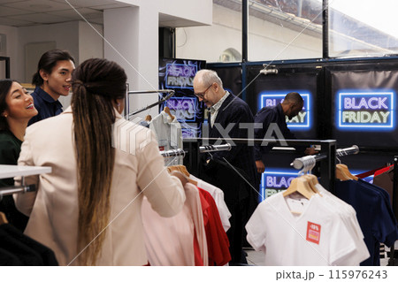 Black Friday store traffic. Diverse people customers buying clothes at discounted prices during sales, crowd of shoppers in shopping mall, hunting for bargains during seasonal fashion discounts Black Friday store traffic. Diverse people customers buying clothes at discounted prices during sales, crowd of shoppers in shopping mall, hunting for bargains during seasonal fashion discounts 115976243