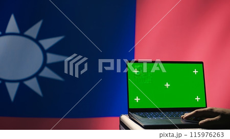 Taiwanese air defense operator uses radar on green screen laptop conducting satellite tracking. Taiwan insurgent uses military software on mockup device, preventing rockets, camera B 115976263