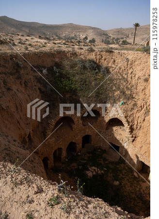 Ancient Berber dwellings carved into walls of earthen pit in Matmata Ancient Berber dwellings carved into walls of earthen pit in Matmata 115978258