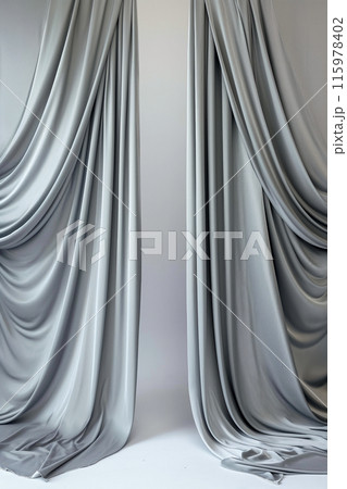 Two long, flowing curtains in a white room 115978402