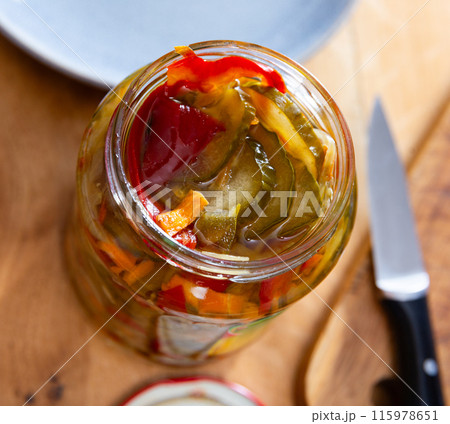 Homemade pickled cucumber salad wild peppers and carrots in jar Homemade pickled cucumber salad wild peppers and carrots in jar 115978651