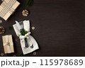 Christmas dinner concept. Forks with a knife on a napkin and Christmas decorations made from natural materials on a dark wooden table. Top view, flat lay. 115978689