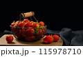 Fresh ripe strawberries in a metal basket on the table 115978710