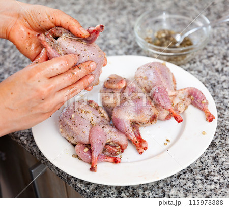 Preparing fresh partridges with spices for roasting 115978888