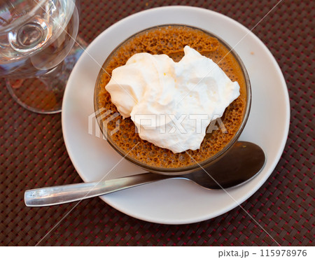 Baked sweet dessert coffee mousse made from fermented milk product, decorated by whipped cream Baked sweet dessert coffee mousse made from fermented milk product, decorated by whipped cream 115978976