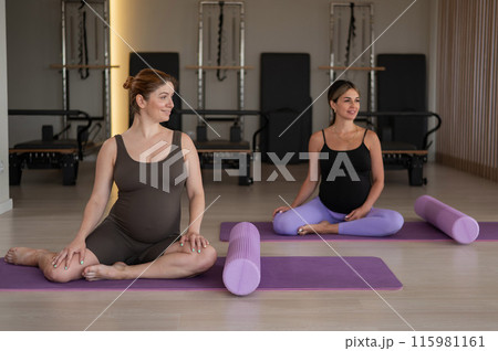Two pregnant women doing yoga. Preparing for the birth of a child.  115981161