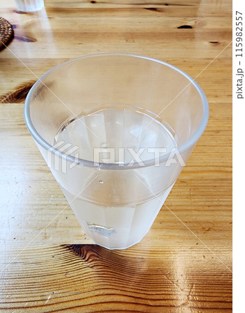 water in a glass on wooden table water in a glass on wooden table 115982557