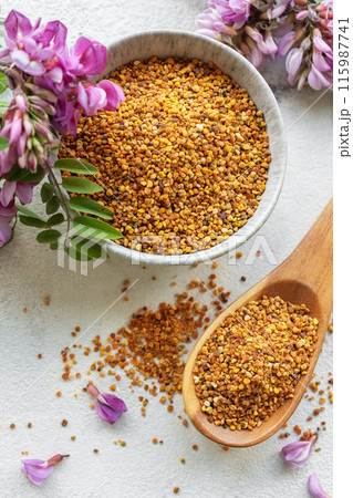 Healthy bee pollen grains.  Bee pollen on a bowl and acacia flowers. 115987741