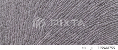 Texture of woolen dark gray textile background from soft wool material, macro. Grey fabric with wavy pattern. 115988755