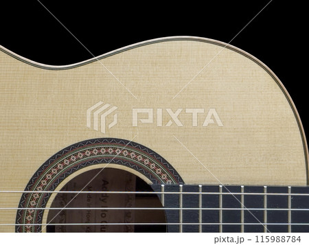 Close up of a Classical Guitar in Black Background 115988784