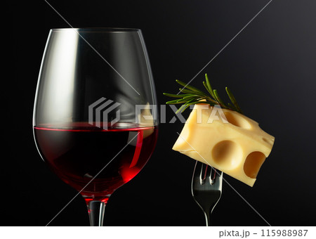 Glass of red wine and cheese with rosemary. 115988987