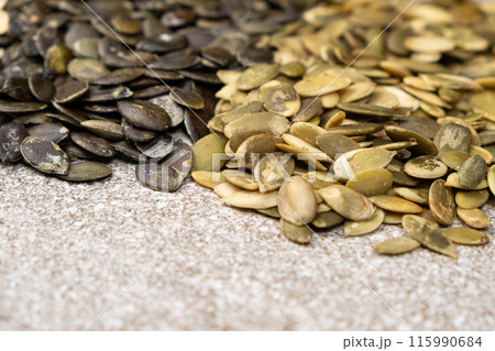 Different types of peeled pumpkin seeds, close-up Different types of peeled pumpkin seeds, close-up 115990684