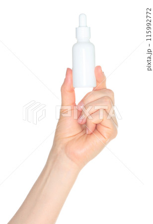 Woman hand holding a white cosmetic bottle, isolated on white background close-up, template 115992772